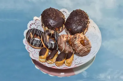 a cake with chocolate covered donuts on a plate at Hotel Daphne in Istanbul