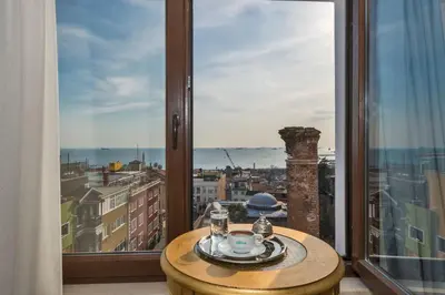 a room with a table and a large window at Hotel Daphne in Istanbul
