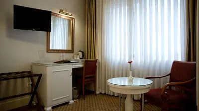 a hotel room with a table and a window at Taksim Metropark Hotel in Istanbul