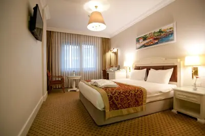 a hotel room with a bed and a television at Taksim Metropark Hotel in Istanbul