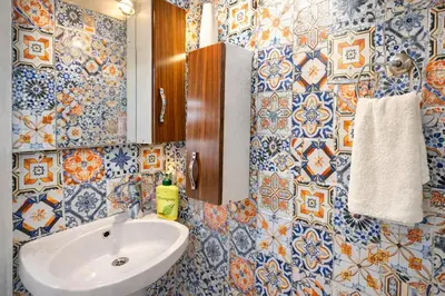 a bathroom with blue and white tile walls and a sink at Sultanahmet Center View Apart Hotel in Istanbul