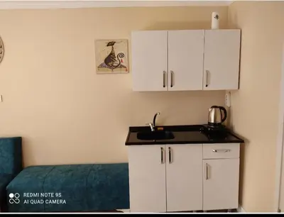a kitchen with white cabinets and a sink at Sultanahmet Center View Apart Hotel in Istanbul