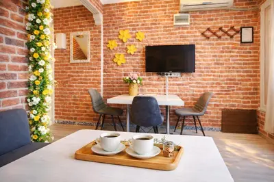 a room with a table and chairs and a brick wall at Sultanahmet Center View Apart Hotel in Istanbul
