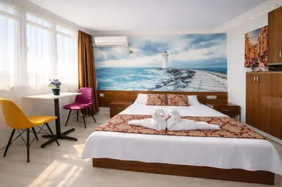a bedroom with a bed and a painting of a lighthouse at Sultanahmet Center View Apart Hotel in Istanbul