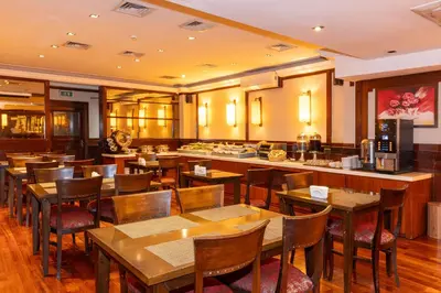 a restaurant with wooden tables and chairs and a bar at Pera Rose Hotel & Spa - Special Category in Istanbul