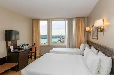 a hotel room with two beds and a window at Pera Rose Hotel & Spa - Special Category in Istanbul