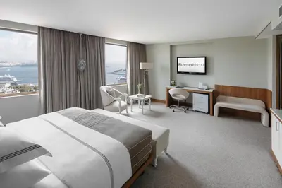 a hotel room with a bed and a desk and window at Richmond Istanbul in Istanbul