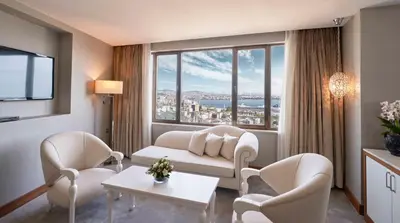 a living room with a couch and chairs and a large window at Richmond Istanbul in Istanbul