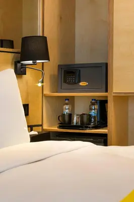 a bedroom with a bed with a microwave and two pots at Trip Park Hotel in Istanbul