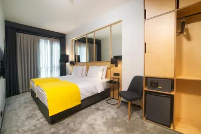 a hotel room with a bed and a yellow blanket at Trip Park Hotel in Istanbul