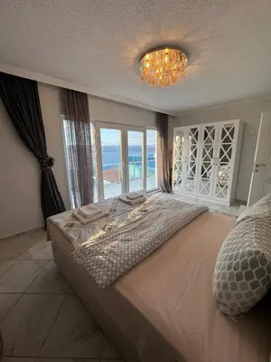 a bedroom with a large bed with a large window at WHİTE ROSE VİLLA Jakuzili ve Isıtma Havuzlu in Sapanca