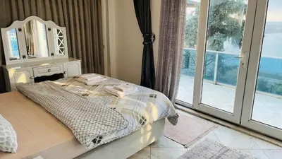 a bedroom with a bed and a large window at WHİTE ROSE VİLLA Jakuzili ve Isıtma Havuzlu in Sapanca