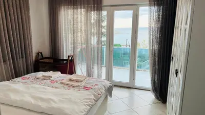 a bedroom with a bed and a sliding glass door at WHİTE ROSE VİLLA Jakuzili ve Isıtma Havuzlu in Sapanca