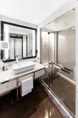 a bathroom with a sink and a shower at The Marmara Taksim in Istanbul