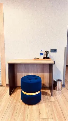 a blue stool sitting in front of a desk at The Green Park Taksim in Istanbul