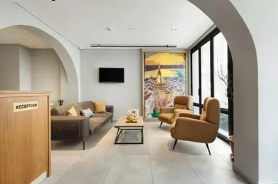 a living room with two couches and a tv at Galata Rasso Hotel in Istanbul