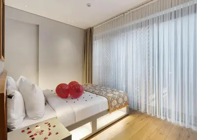 a bedroom with a bed with two red pillows on it at Galata Rasso Hotel in Istanbul