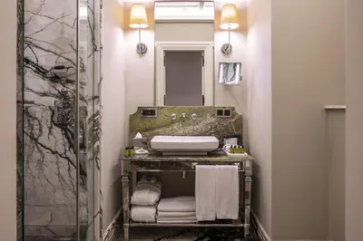a bathroom with a sink and a mirror at The Bank Hotel Istanbul, a Member of Design Hotels in Istanbul