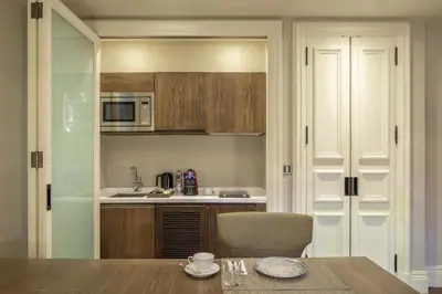 a kitchen with a wooden table and a dining room at The Bank Hotel Istanbul, a Member of Design Hotels in Istanbul