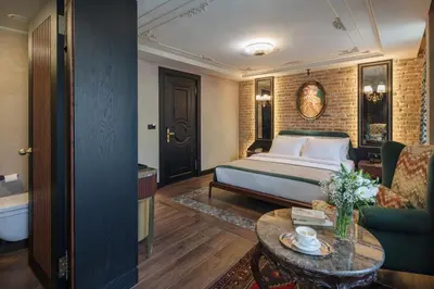 a hotel room with a bed and a couch and a table at Tria Hotel Istanbul-Special Category in Istanbul