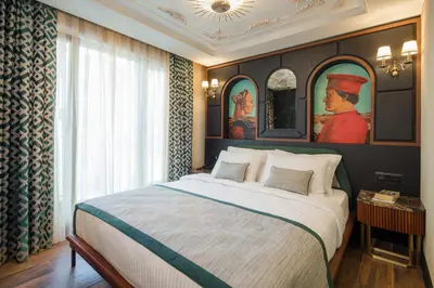 a bedroom with a large bed with a painting on the wall at Tria Hotel Istanbul-Special Category in Istanbul