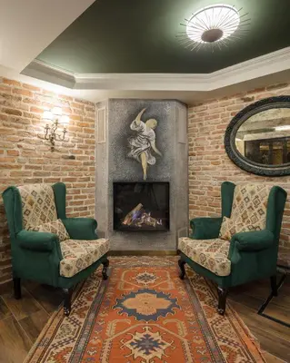 a living room with two chairs and a fireplace at Tria Hotel Istanbul-Special Category in Istanbul