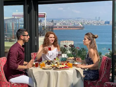a group of people sitting at a table eating food at Tria Hotel Istanbul-Special Category in Istanbul