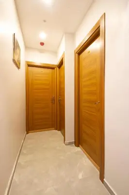 a corridor with two wooden doors in a room at Turna Hotel in Istanbul