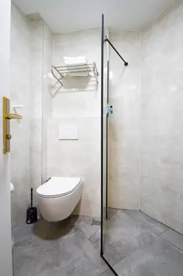 a bathroom with a toilet and a glass shower at Turna Hotel in Istanbul