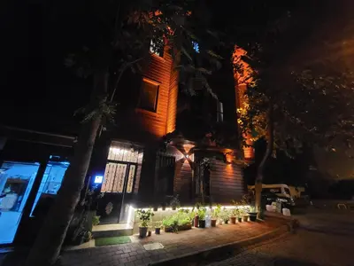 a building with a bunch of plants in front of it at night at Turna Hotel in Istanbul