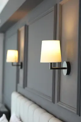 two lights on a wall next to a couch at FONTANA VERDE in Istanbul