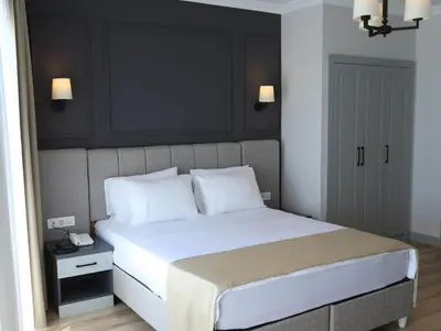 a bedroom with a large bed with white pillows at FONTANA VERDE in Istanbul
