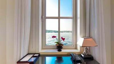 a window with a vase with flowers on a desk at A'jia Hotel in Istanbul
