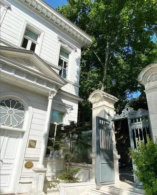 a white house with a door and a tree at A'jia Hotel in Istanbul