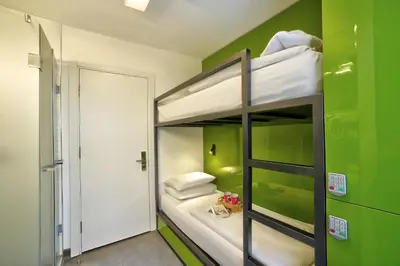 a bunk bed in a room with a green wall at The Central House Istanbul Taksim in Istanbul