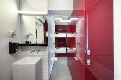 a red bathroom with a toilet and a red door at The Central House Istanbul Taksim in Istanbul