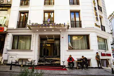 two people sitting in front of a hotel at Silvana Hotel in Istanbul