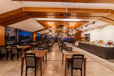a restaurant with wooden ceilings and tables and chairs at Demiray Hotel Old City in Istanbul