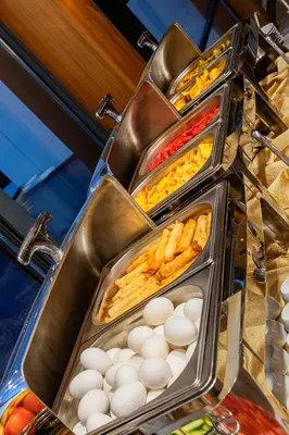 a buffet line with eggs and other food items at Demiray Hotel Old City in Istanbul