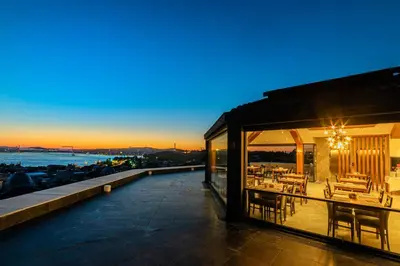 a house with a balcony with a table and chairs at Demiray Hotel Old City in Istanbul