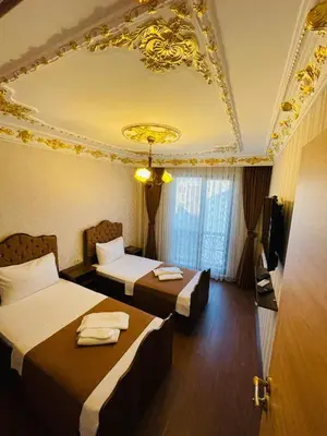 a hotel room with two beds and a ceiling at fafsuitehome in Istanbul