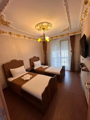 a hotel room with two beds and a television at fafsuitehome in Istanbul