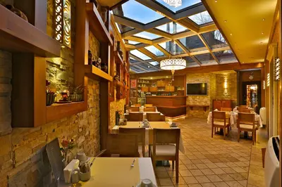 a restaurant with tables and chairs and a glass ceiling at The Million Stone Hotel - Special Category in Istanbul