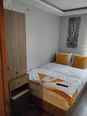 a bedroom with a bed and a dresser at Mr Lion Kumkapı Otel in Istanbul