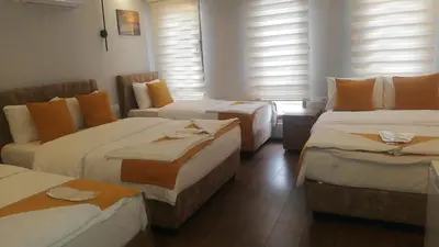 a hotel room with three beds and a couch at Mr Lion Kumkapı Otel in Istanbul