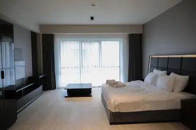 a bedroom with a large bed and a large window at Hotel54 in Sakarya