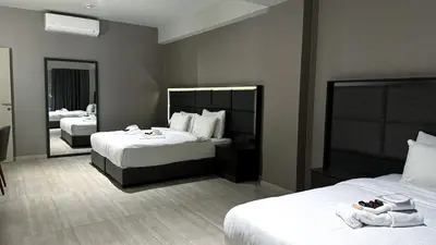 a hotel room with two beds and a mirror at Hotel54 in Sakarya