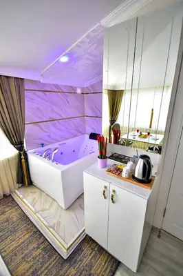 a bathroom with a purple tub in a room at LOCA Suit LİFE AİRPORT HOTEL in Istanbul