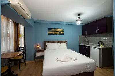 a bedroom with a large bed and a blue wall at Taksim Antique Hotel in Istanbul