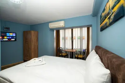 a bedroom with a bed in a room with blue walls at Taksim Antique Hotel in Istanbul